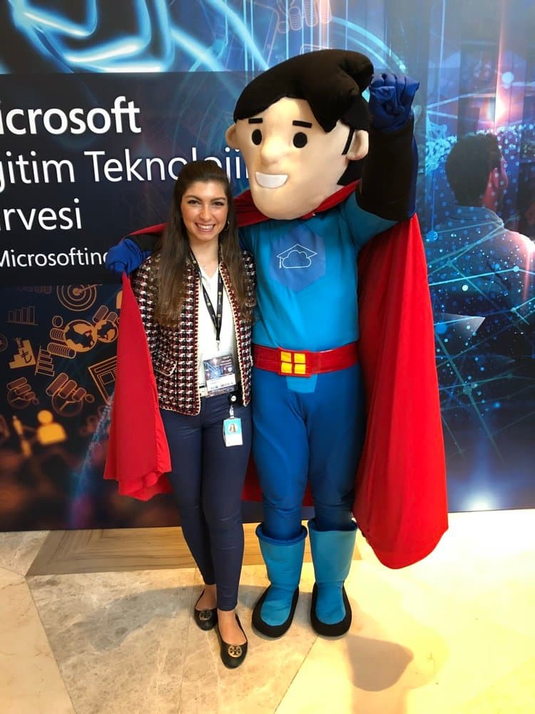 Ecem with a mascot at a Microsoft education event