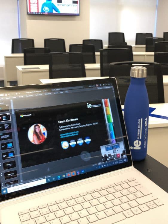 Ecem's laptop and IE Business School bottle in a classroom before a lecture