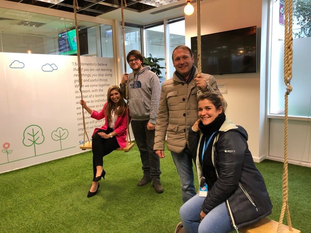 Ecem with colleagues on rope swings at a Microsoft office